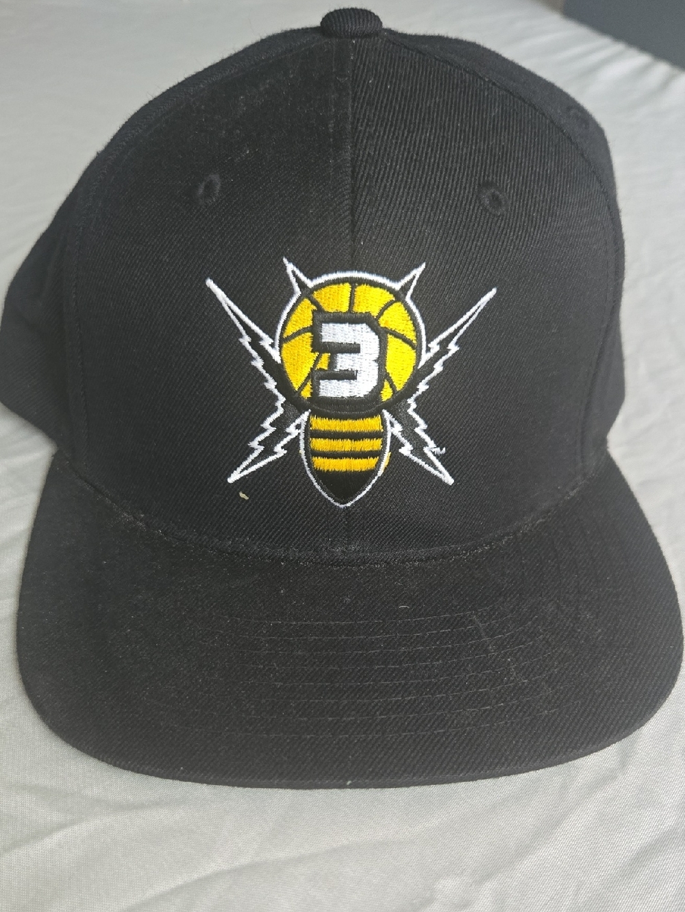 Black Snapback Hat with Yellow Bee Basketball Logo